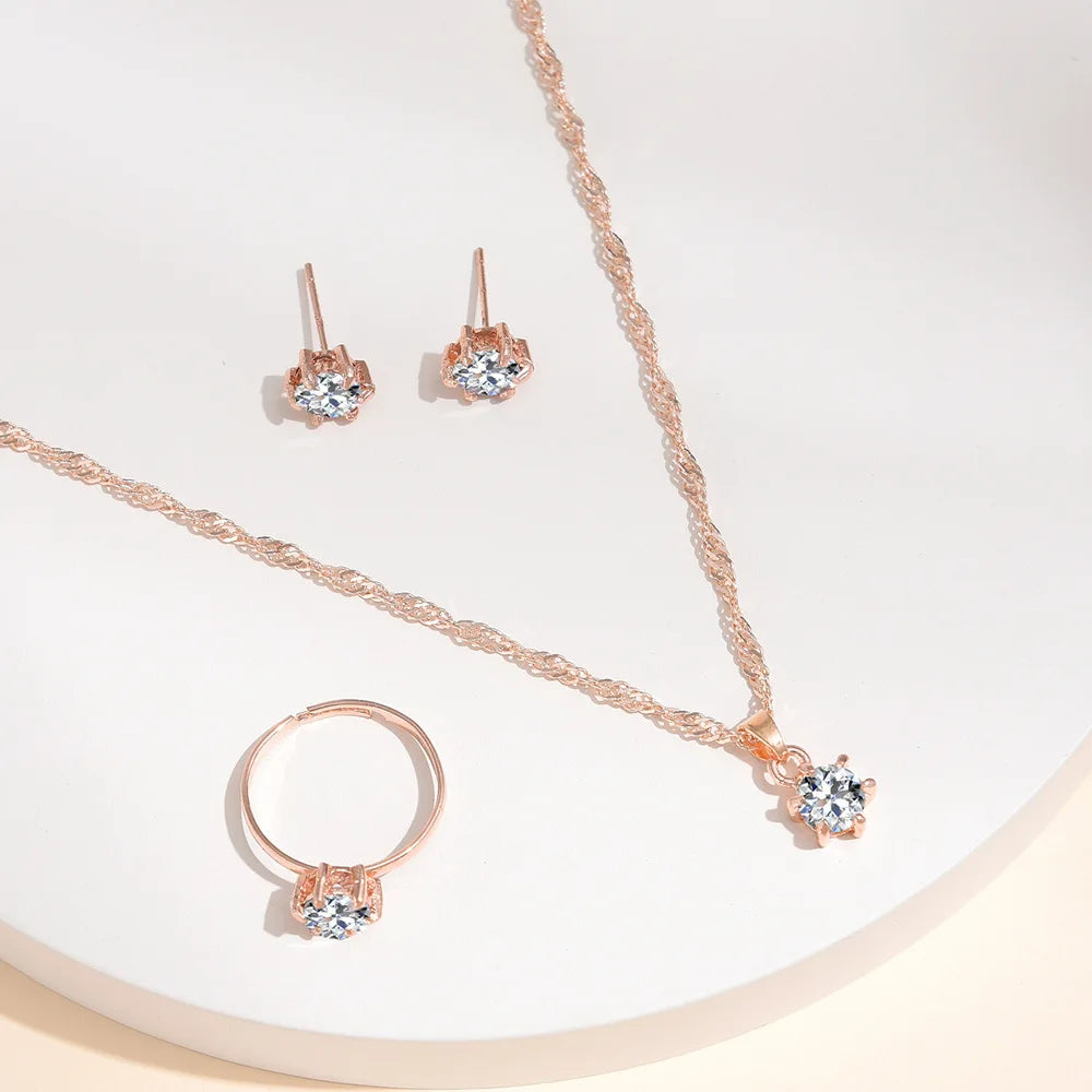 Alt Tag: 5 piece crystal jewelry set for women rose gold necklace, ring and stud earrings with clear crystal stones