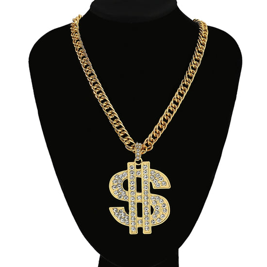 Gold dollar pendant necklace with rhinestones on a gold chain showcased on a black display stand.