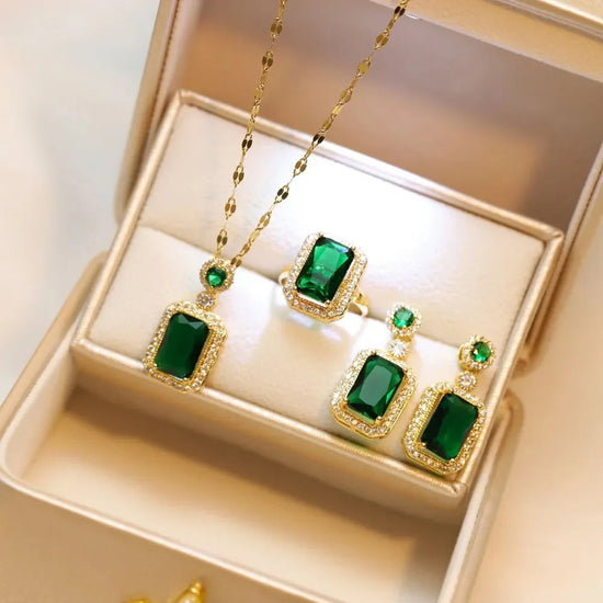 Alt Tag: 4 piece rhinestone bridal jewelry set with emerald green pendant necklace, ring and drop earrings in gold tone gift box