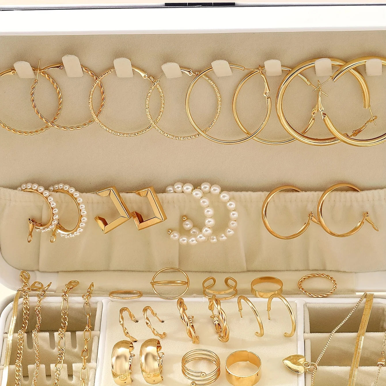 Alt Tag: 54 piece fashion jewelry set with gold hoop earrings, pearl hoops, rings, and bracelets in organized display case