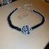 Alt Tag: crystal flower rhinestone choker necklace set with black rhinestone band and sparkling crystal flower centerpiece