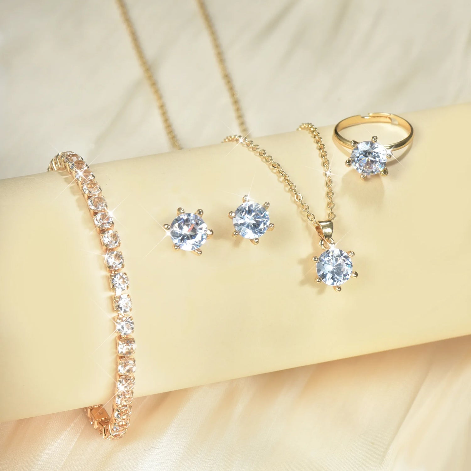 Alt Tag: 5 piece crystal jewelry set for women with gold-tone ring, necklace pendant, stud earrings and tennis bracelet