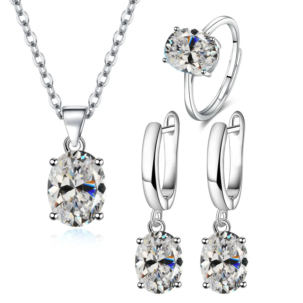 Alt Tag: 925 sterling silver bridal jewelry set with oval crystal pendant necklace, matching drop earrings and solitaire ring for wedding