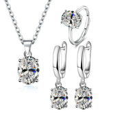 Alt Tag: 925 sterling silver bridal jewelry set with oval crystal pendant necklace, matching drop earrings and solitaire ring for wedding