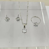 Alt Tag: 5 piece crystal jewelry set for women with silver necklace pendant, stud earrings and ring on display