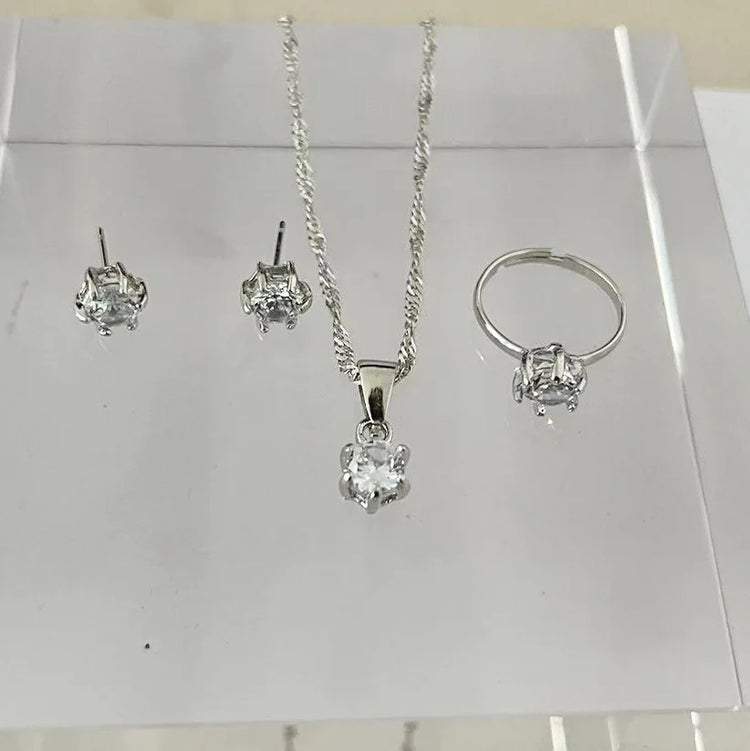 Alt Tag: 5 piece crystal jewelry set for women with silver necklace pendant, stud earrings and ring on display