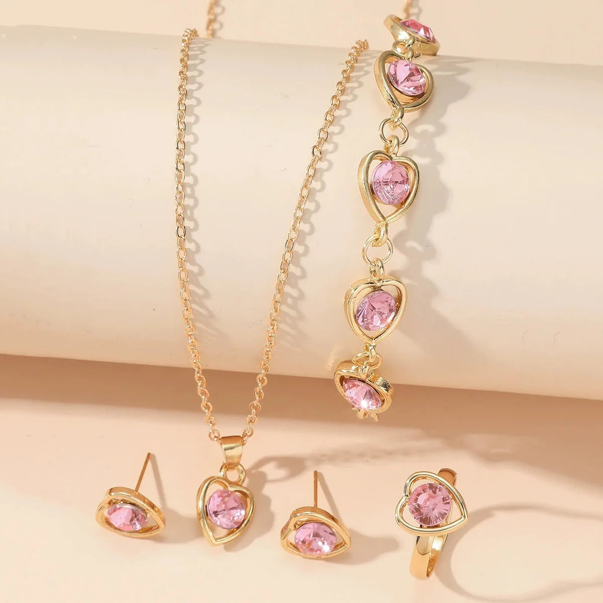 Alt Tag: heart crystal jewelry set for women gold-tone necklace bracelet earrings ring with pink heart crystals