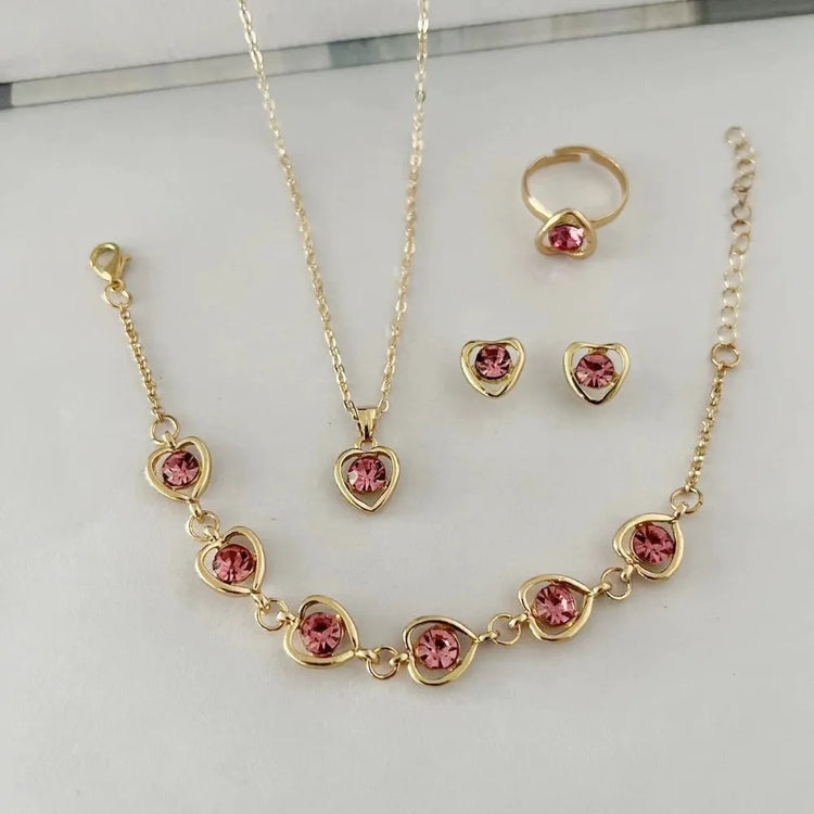 Alt Tag: heart crystal jewelry set for women gold-tone necklace bracelet ring and stud earrings with pink heart crystals